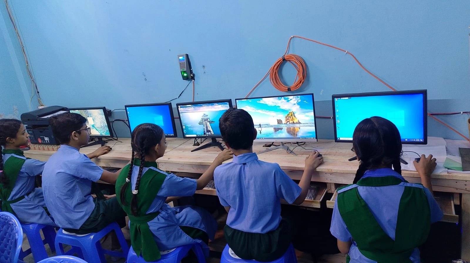 Students learning on computers at a HAKF digital lab