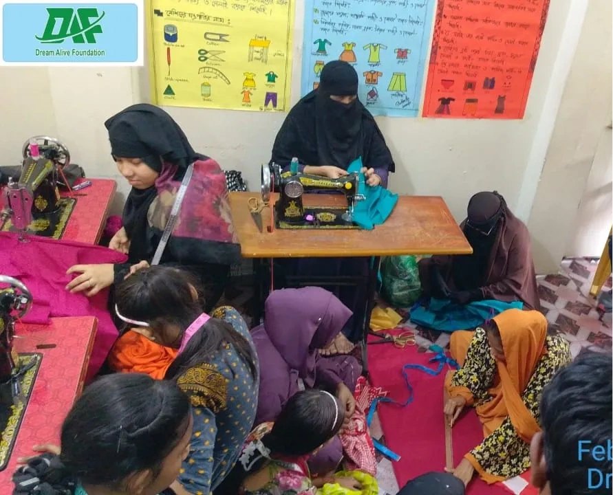 Women training on sewing machines at a HAKF-funded skills center